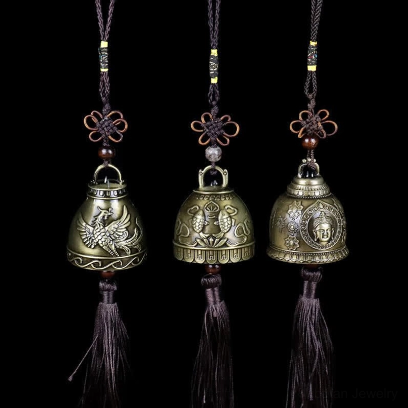 Three-piece feng shui wind chime set with Buddha, Phoenix, and Koi Fish embossed designs on black background