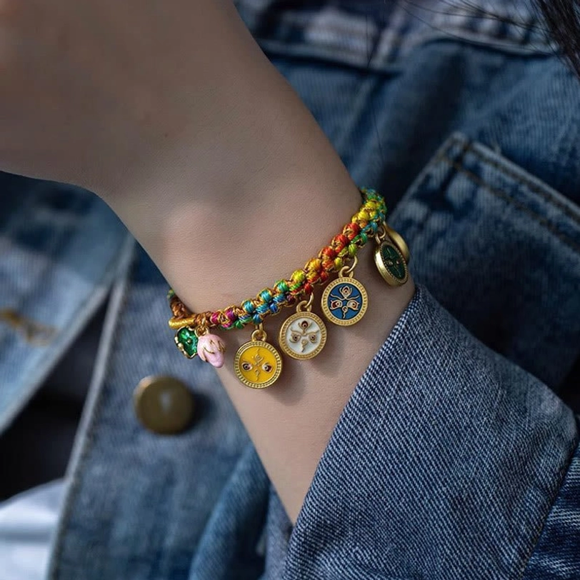 Tibetan five gods braided luck bracelet worn on wrist with denim jacket background showing daily casual wear