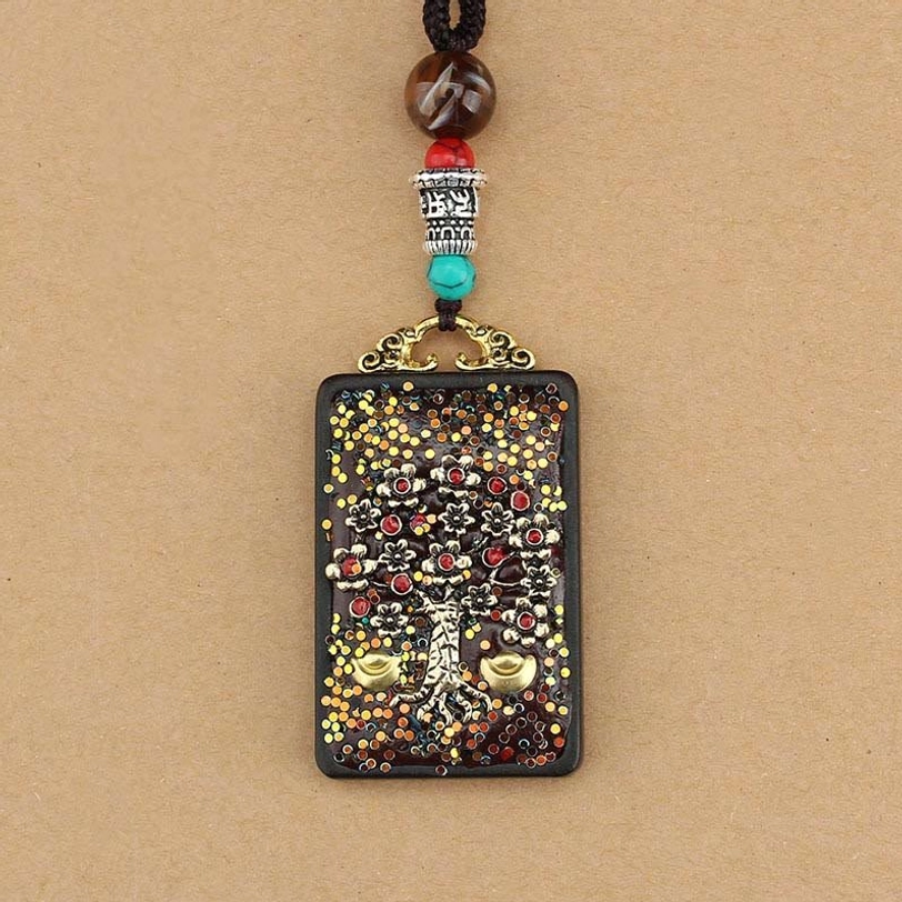 Five Gods of Wealth thangka pendant detail showing sacred Buddhist iconography and artisan handcrafted quality on natural ebony wood