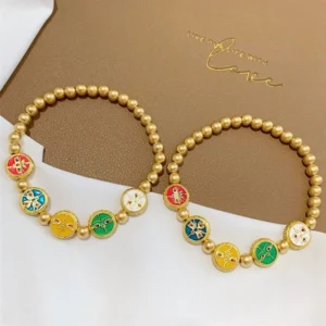 Pair of five gods of wealth Tibetan copper beads luck bracelets displayed together on brown card with white fabric backdrop, showing all enamel charm details