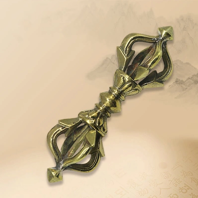 Full five-prong vajra dorje in antique brass copper, flat lay overhead view with perfectly symmetrical design on light background with subtle pattern