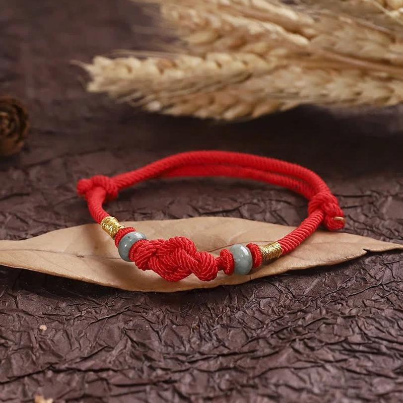 Fortune knot bracelet with adjustable toggle on rustic wooden table with natural elements