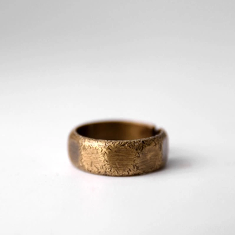 Frosted copper prosperity ring - three-quarter side view on white background with minimalist open cuff display