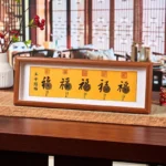 Fu character five-emperor coins feng shui wood frame with golden Fu character and antique copper coins on yellow background, front view
