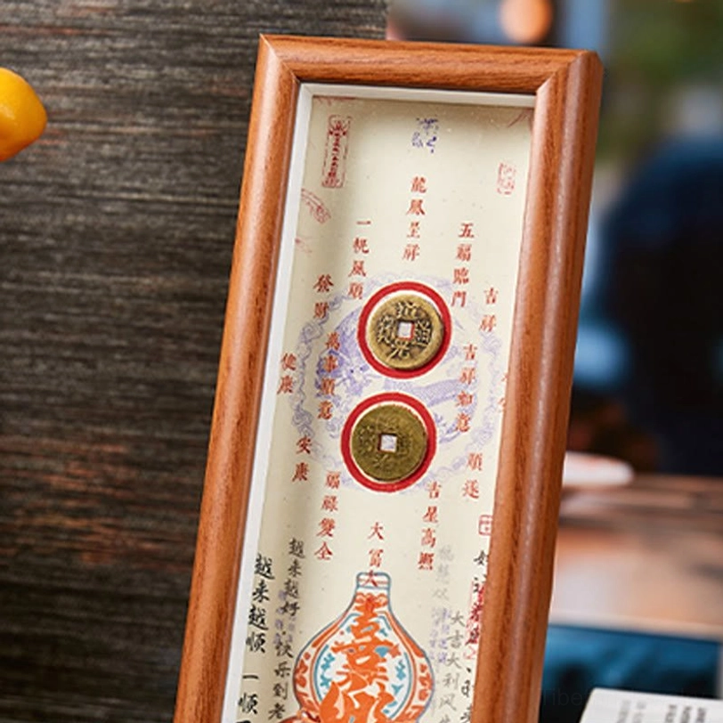 Close-up of handcrafted fu frame with antique copper coins and chinese calligraphy panel