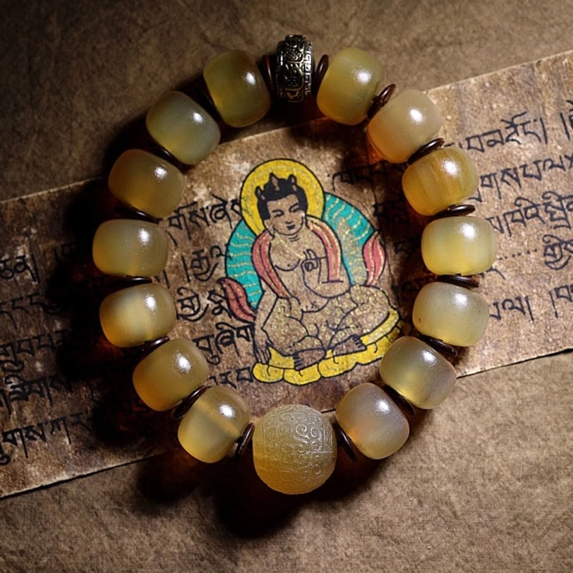 Complete Tibetan sheep horn Om Mani Padme Hum bracelet laid flat showing full design with metal accents