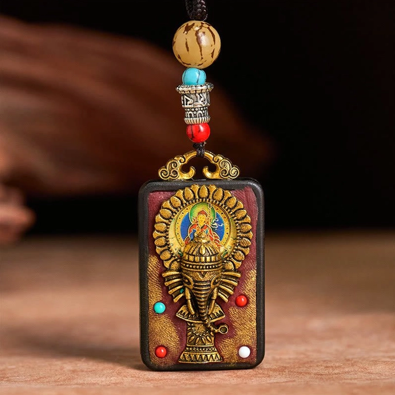 Ganesha wisdom pendant necklace close-up showing intricate carving and gold accents