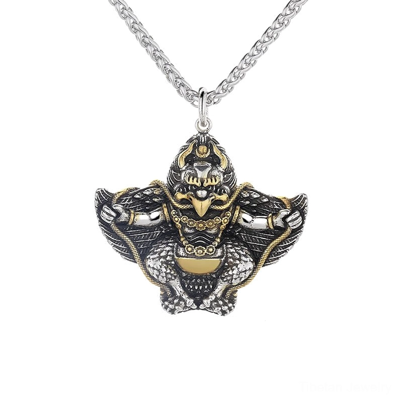 Full frontal view of Tibetan Garuda Bird pendant showing two-tone carved design with matching wheat link chain
