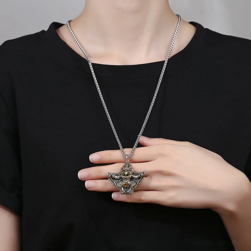 Woman wearing Tibetan Garuda Bird copper protection necklace with long wheat chain paired with black casual t-shirt