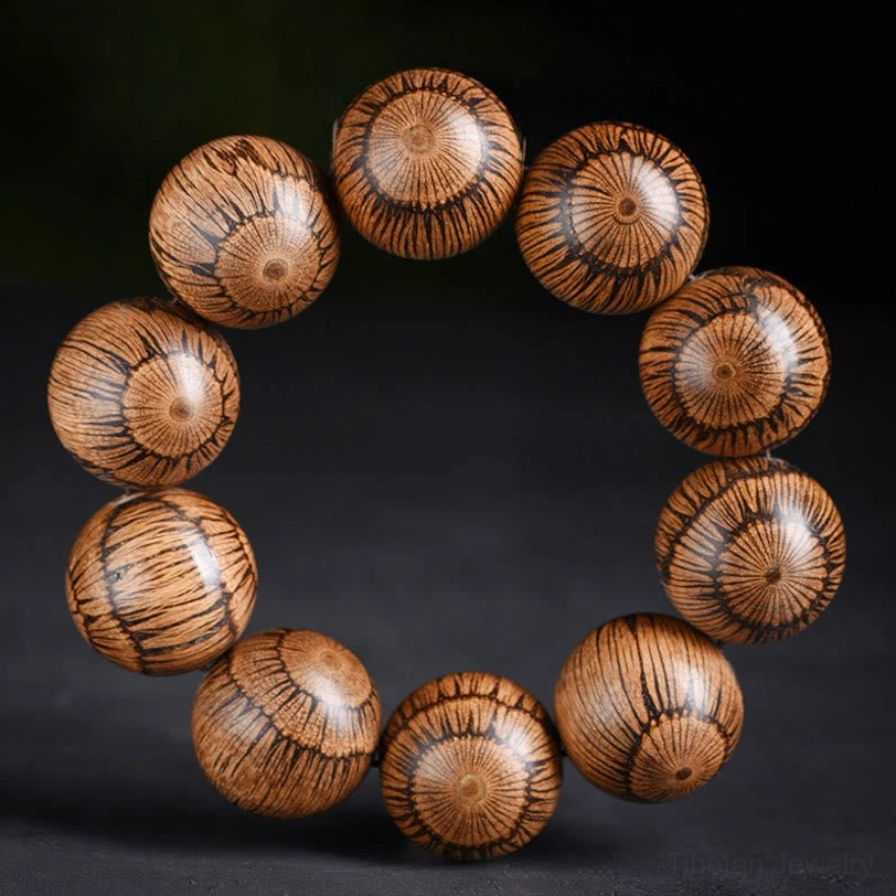 Gnetum wood beaded bracelet 25mm size with prominent dark radial grain pattern on polished round beads