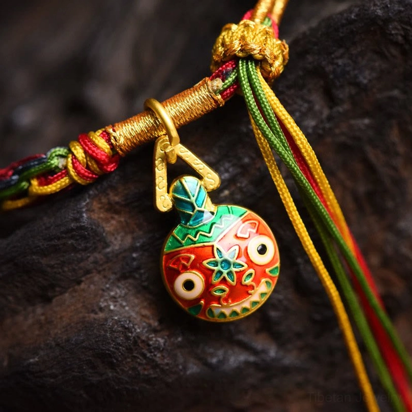 Gold swallowing beast enamel pendant macro close-up with colorful beast design gold knot hardware multicolor beaded tassel