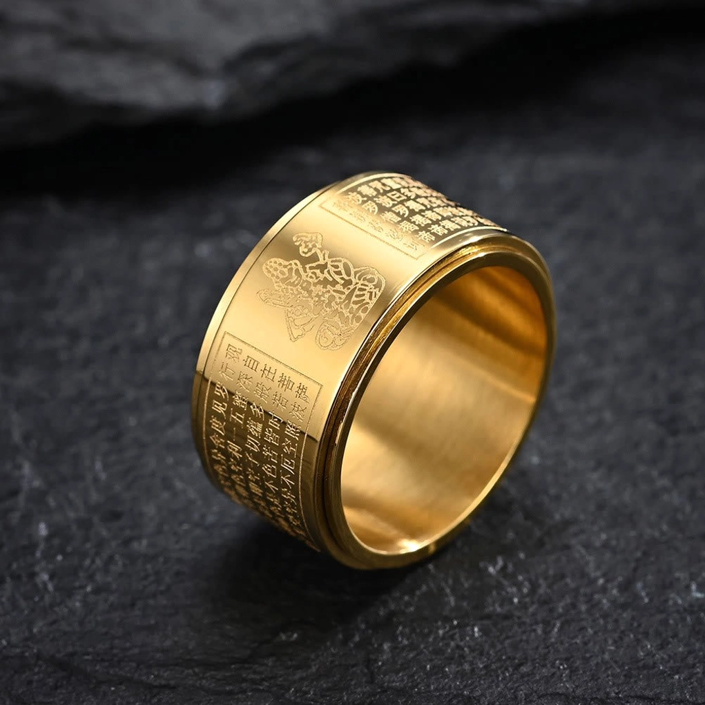 Gold-plated titanium steel spinning Buddha sutra ring with deity and sacred text engraving on dark stone