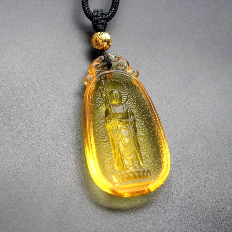 Gold Ksitigarbha Buddha Liuli crystal pendant, handcrafted Tibetan Bodhisattva necklace with protective spiritual energy and divine compassion symbolism