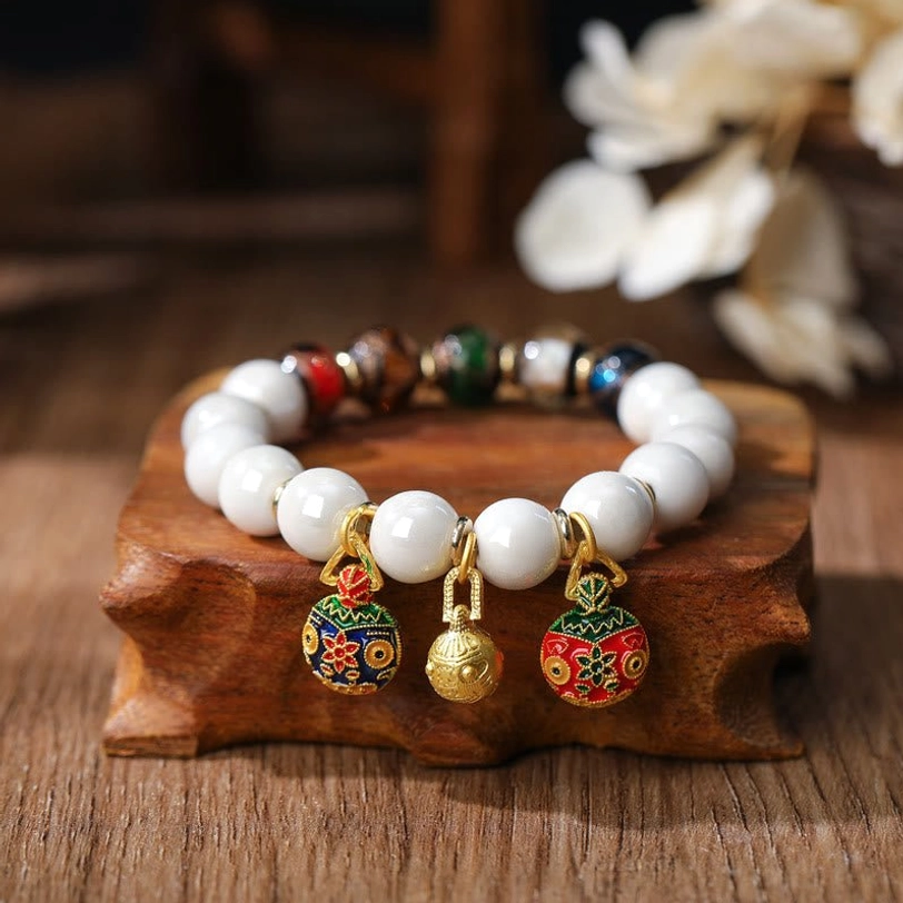Gold Pixiu family charm bracelet featuring vibrant multicolored porcelain and glass beads with traditional enamel hanging pendants