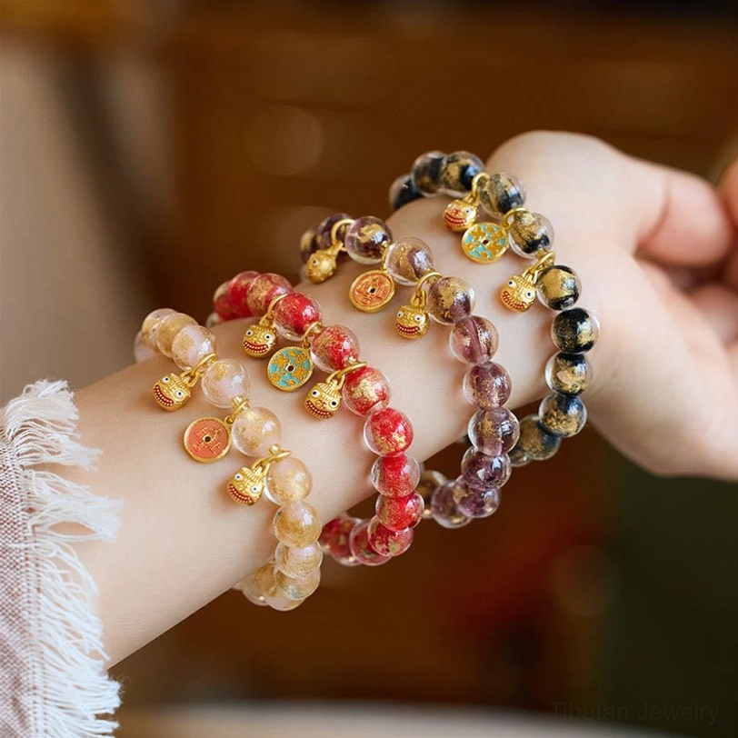 Multi-style gold Pi Xiu fortune bracelets with liuli glass beads and lucky charms, side wrist-worn view