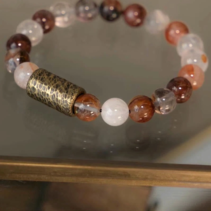 Prosperity and abundance bracelet featuring gold rutilated quartz beads on elastic cord with copper spacer