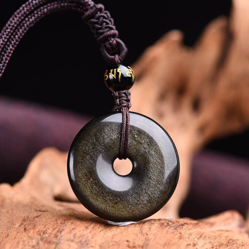 Gold sheen obsidian protection necklace front close-up with golden speckled texture and woven brown cord