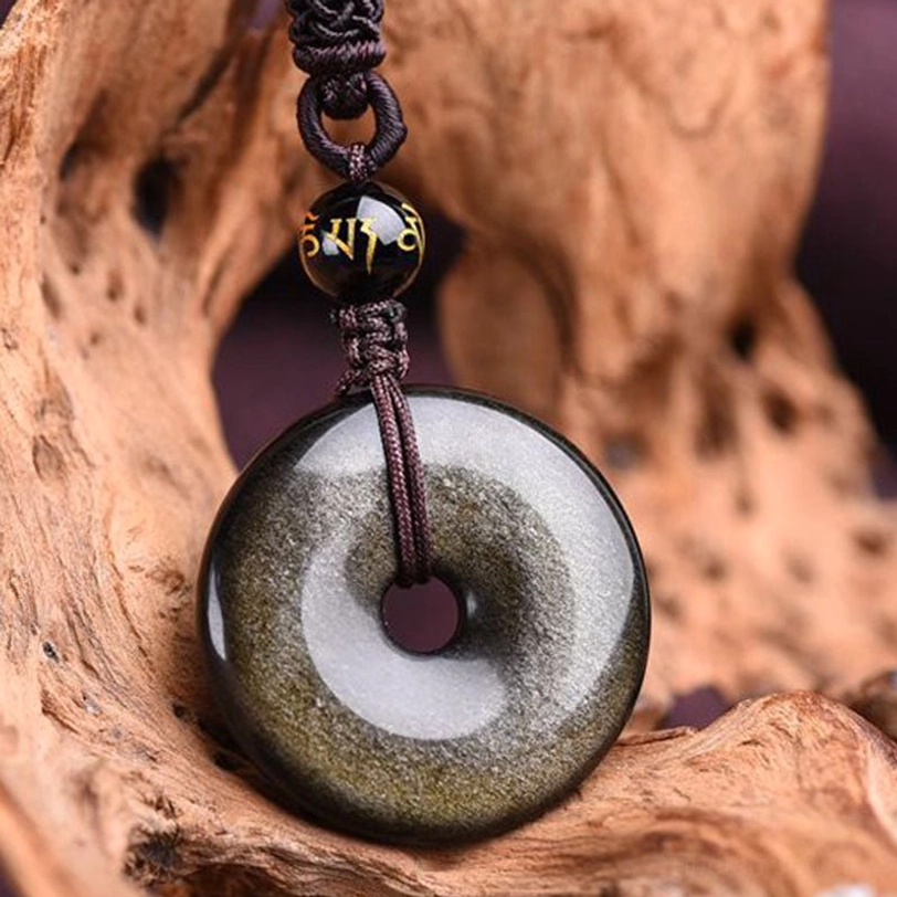 Gold sheen obsidian peace buckle necklace side view displaying refined braided knot and golden highlights