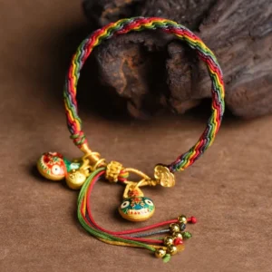 Gold swallowing beast luck knot bracelet rainbow braided rope with multiple enamel beast pendants and gold accents front view