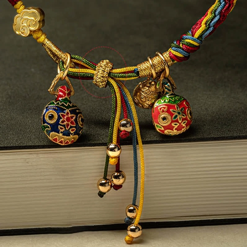 Gold Swallowing Beast prosperity cord bracelet close-up showing intricate weaving and sacred charm details