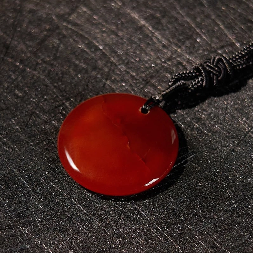 Green aventurine Buddhist pendant showing vibrant color and natural patterns