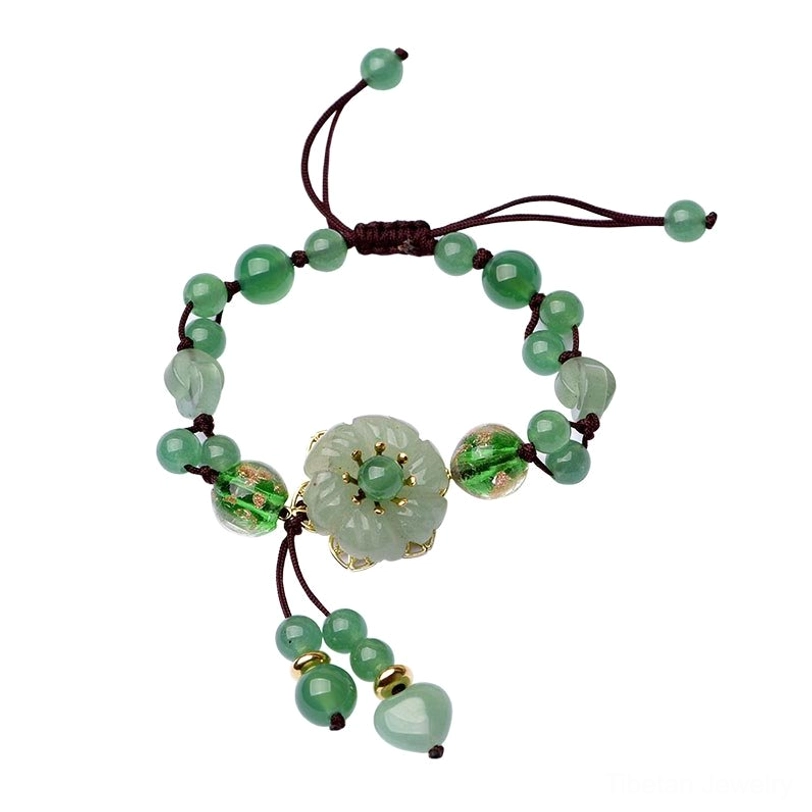 Adjustable green jade bracelet with hanging braided rope and dangling bead set on white background showing full design
