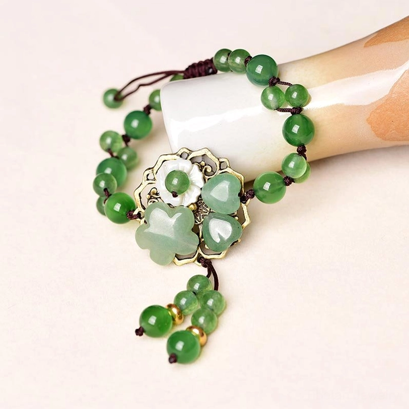 Flower and Love style green jade bracelet variant with delicate dangling charm and adjustable fit