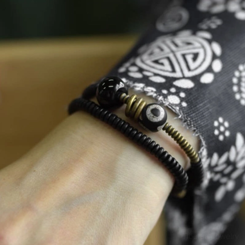 Double wrap Tibetan bracelet featuring green sandalwood and protective Dzi bead accent