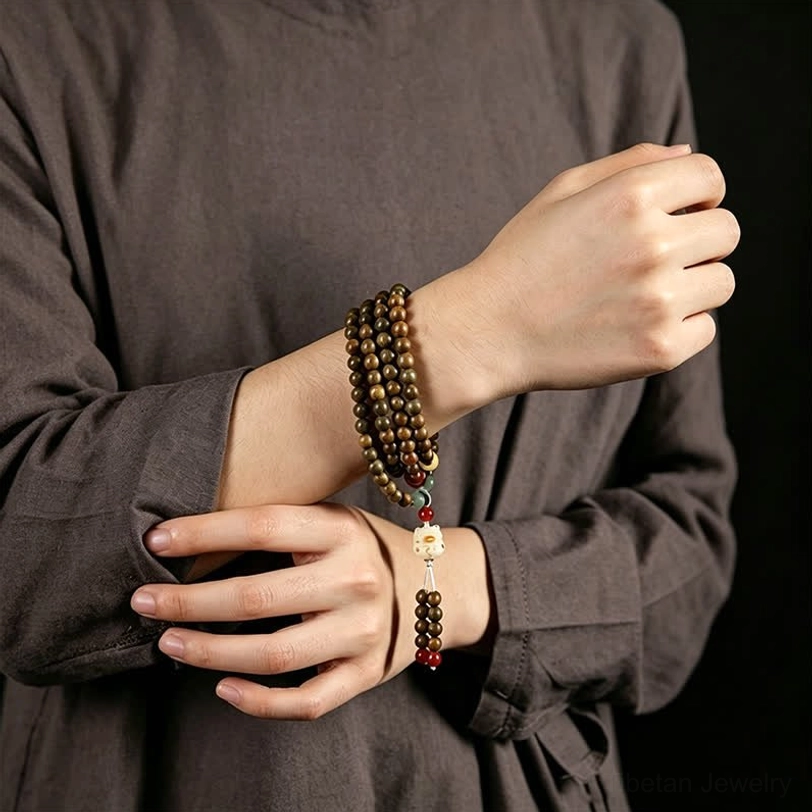 Green sandalwood mala bracelet showing natural grain texture and bead quality close-up detail shot