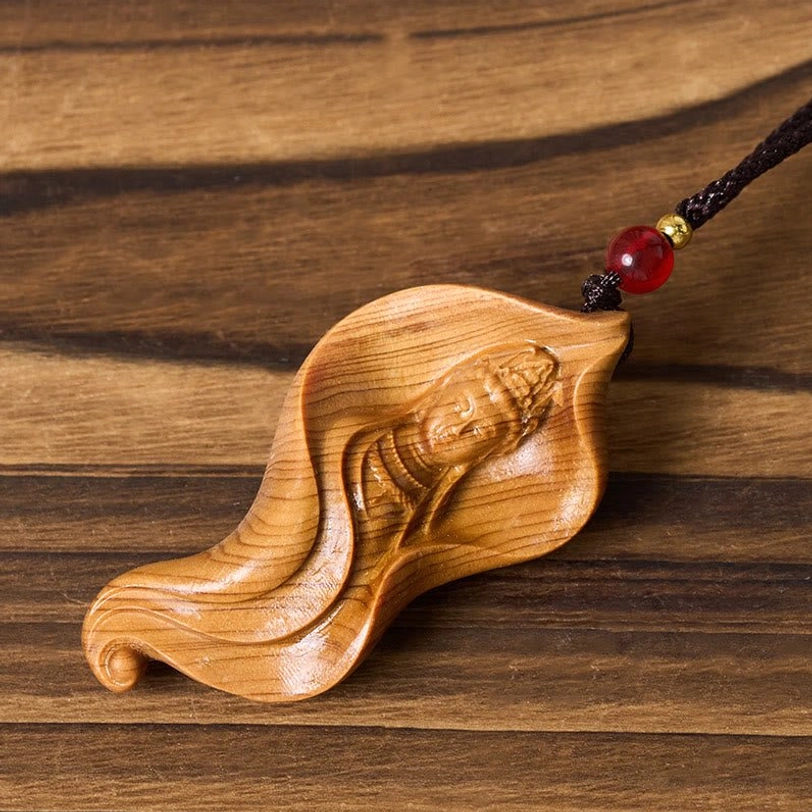 Guanyin Bodhisattva wooden pendant profile - right rear view showing leaf-shaped silhouette and carved Guanyin profile