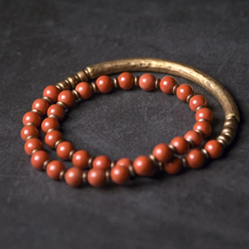 Textured aged bronze hammered copper cuff bracelet with metal accents - close-up