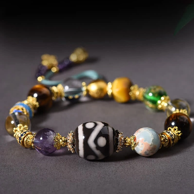 Close-up detail of hand-painted Dzi bead and gemstone arrangement