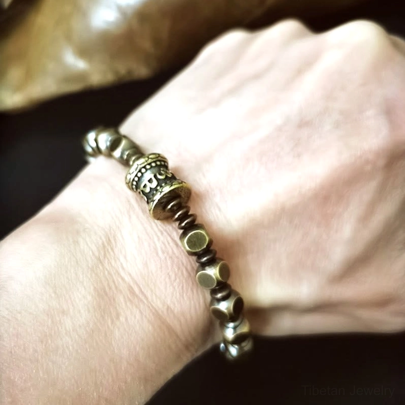 Handcrafted brass Om Mani Padme Hum amulet bracelet showcasing authentic Tibetan spiritual symbolism