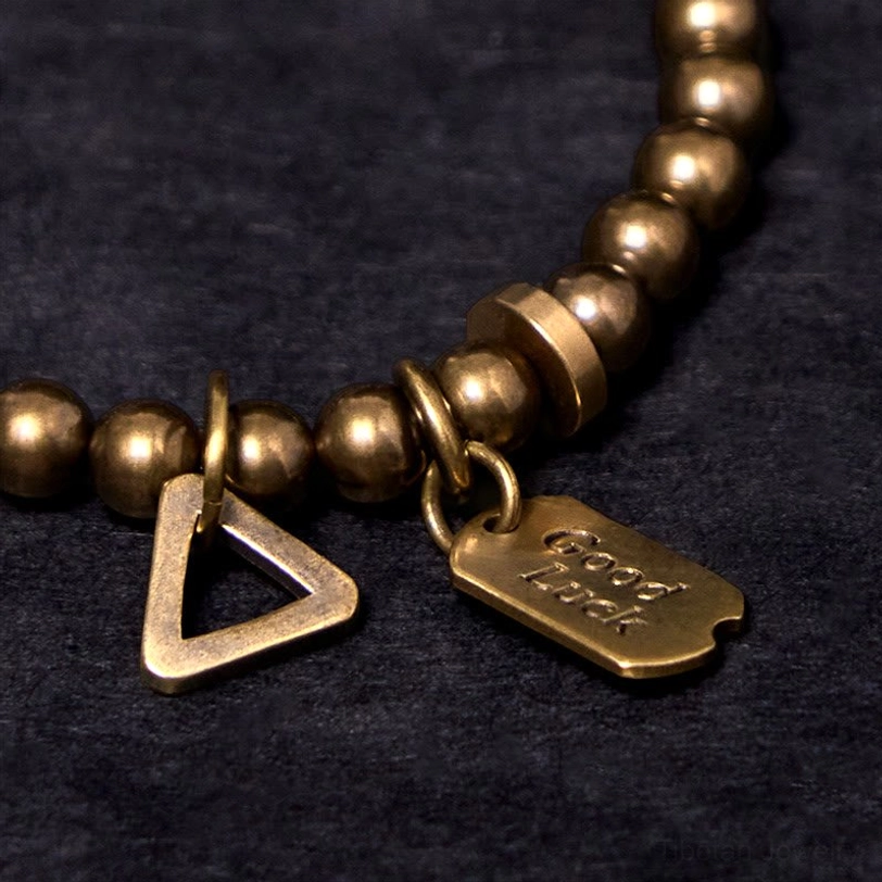 Handcrafted copper brass luck bracelet artisan workmanship detail showing metal quality and bead polish