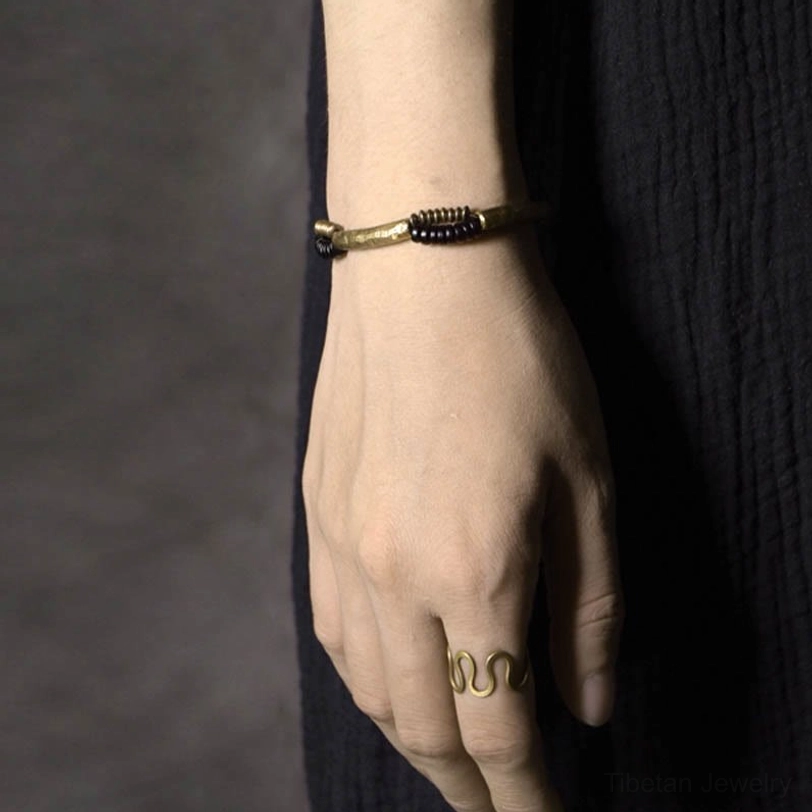 Handcrafted ebony wood and copper bracelet artisan detail view showing natural wood grain