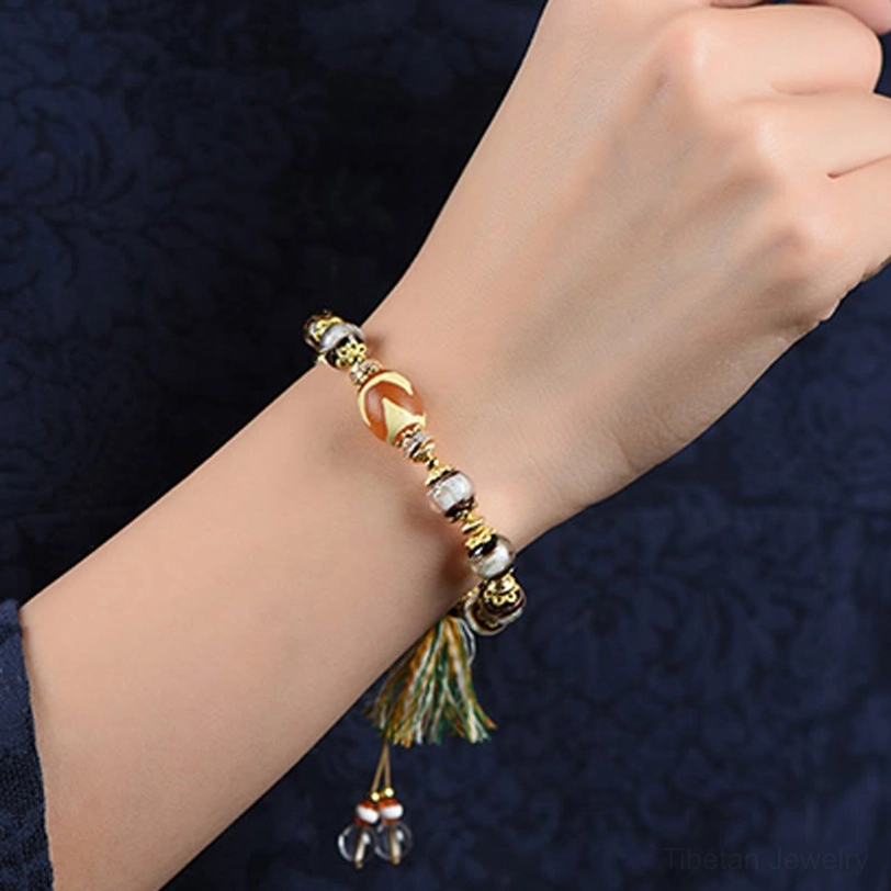 Premium handcrafted Nine-Eye Dzi bead bracelet with Liuli glass in natural studio lighting