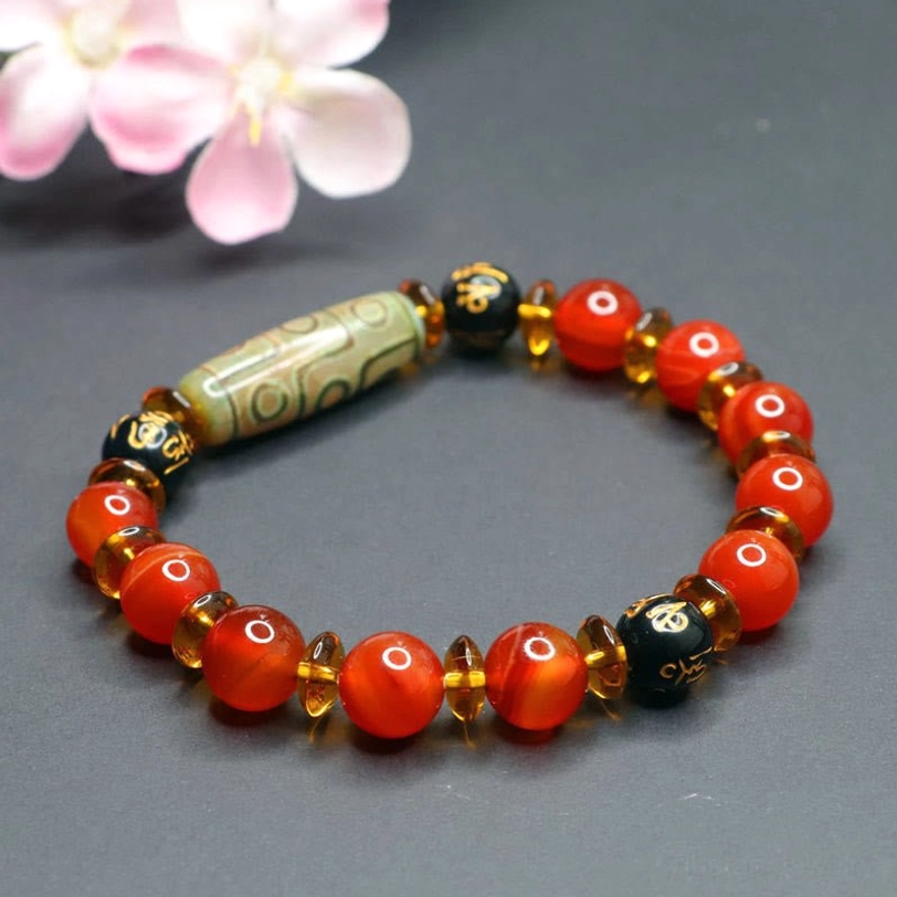 Red agate and nine-eye dzi bead bracelet artisan handcrafted details showing natural material quality and master craftsman creation process