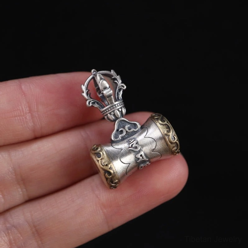 Handcrafted Tibetan dorje bell pendant showcasing artisan craftsmanship and Buddhist religious iconography