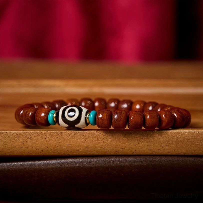 Handcrafted Tibetan Dzi bone bead bracelet detail with protective amulet styling