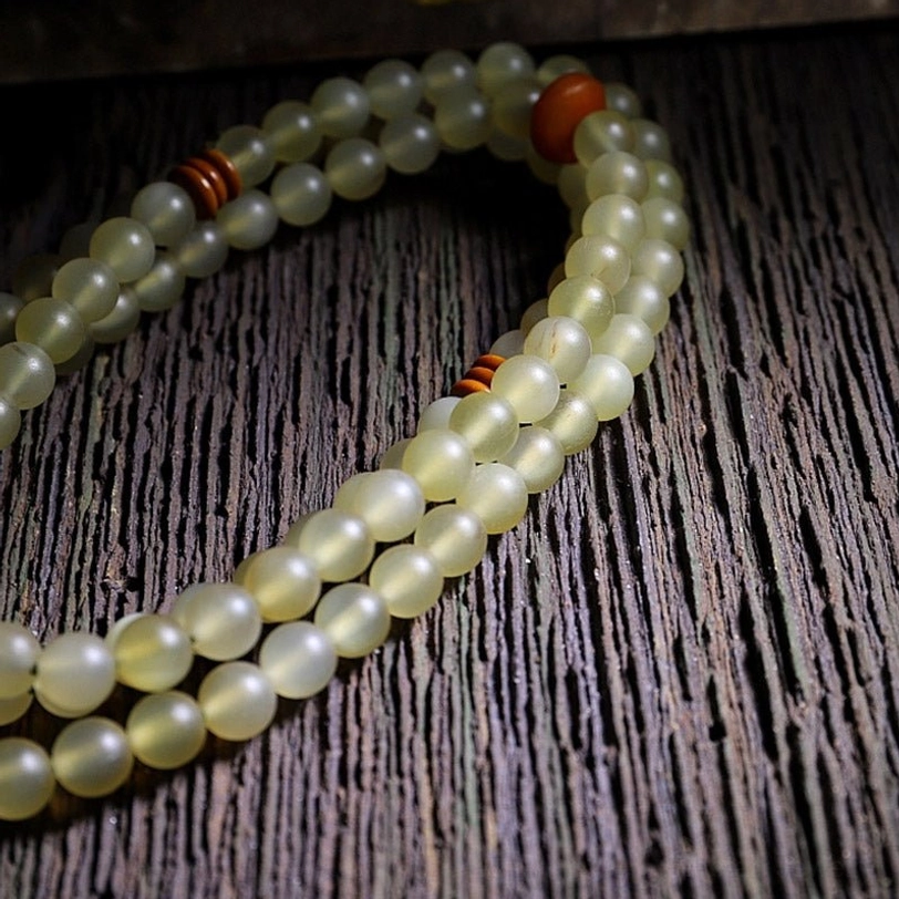 Handcrafted Tibetan sheep horn mala bracelet with natural amber accents and traditional guru bead