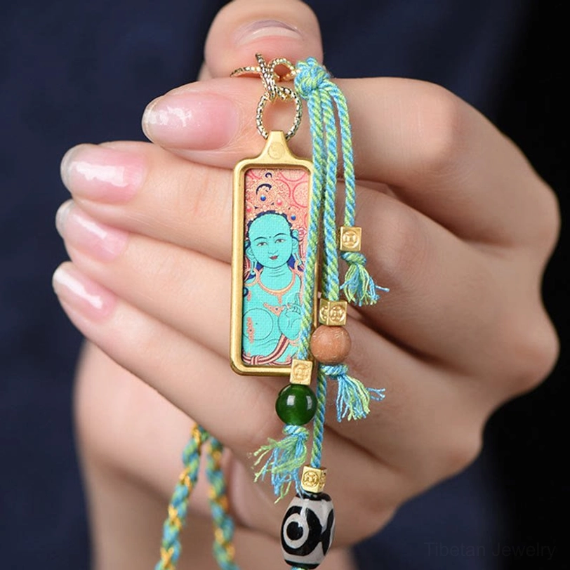 Handcrafted Tibetan thangka pendant necklace showing artisan detail and traditional woven elements