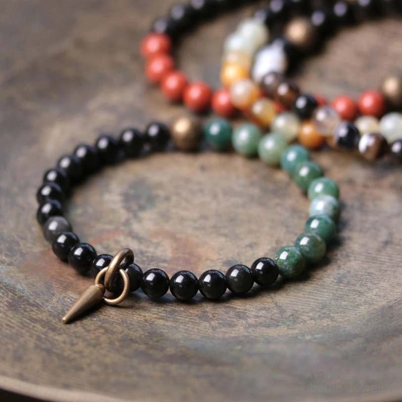 Handmade black Obsidian and stone couple bracelets on natural background - spiritual protection and connection jewelry