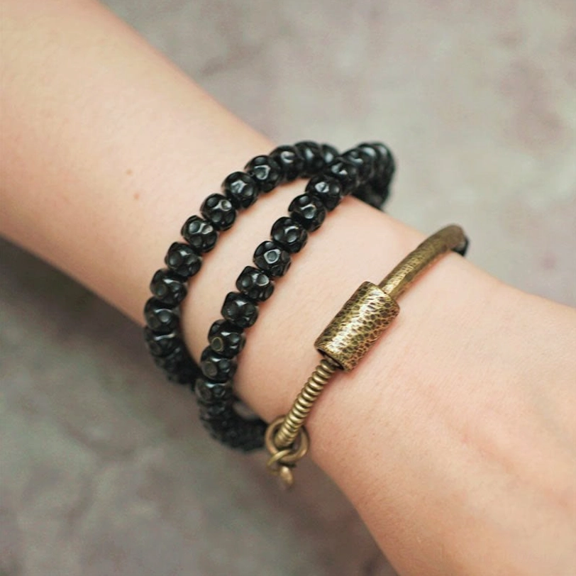 Handmade coconut shell beaded bracelet with brass accents - bohemian triple wrap design for spiritual seekers