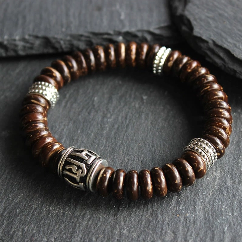 Handcrafted coconut shell Tibetan bracelet showing individual bead artistry and engraved mantra detail