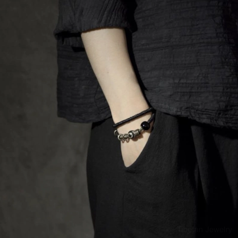 Handcrafted Dzi bead protection bracelet with ebony wood sandalwood and onyx details