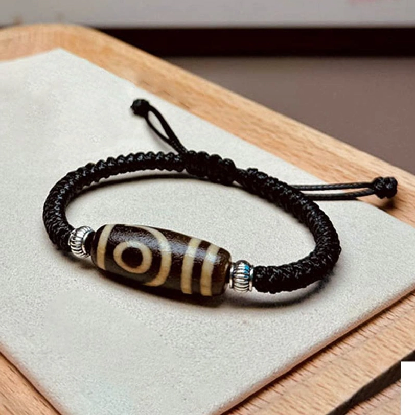 Handmade tibetan dzi bead bracelet artisan craftsmanship detail showing natural material authenticity and color variations