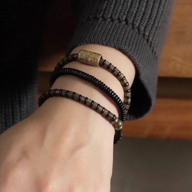 Handmade ebony wood and copper beaded bracelet showing artisanal craftsmanship