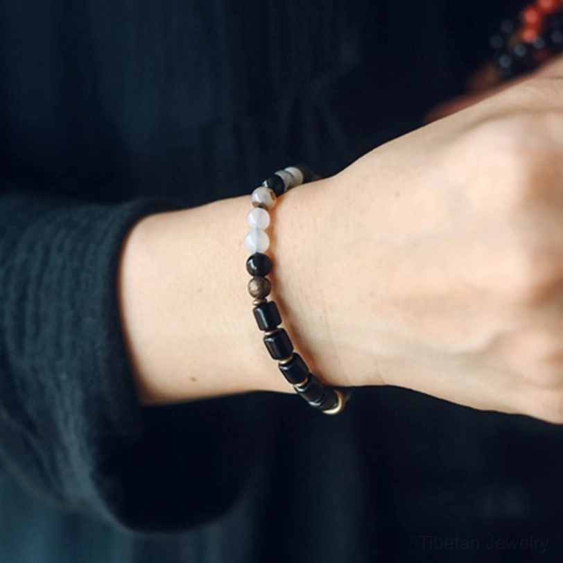 Handmade ebony and gemstone healing crystal bracelet showing artisan craftsmanship with natural stone variations
