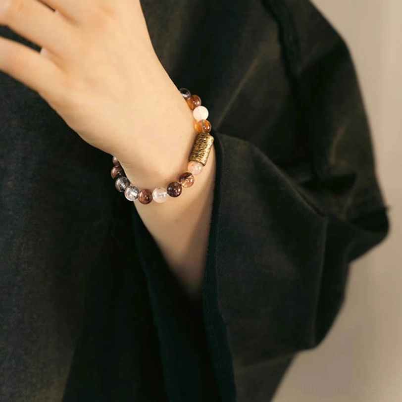 Handmade crystal bracelet showing artisan craftsmanship with copper spacer and natural stone variations
