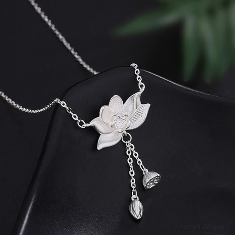 Exquisite 999 silver lotus pod pendant with intricate carving and hanging bud charm on black leather display
